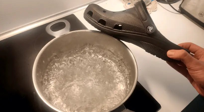 crocs next to a pot with boiling water