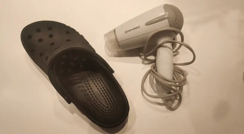 Crocs and hair dryer next to each other