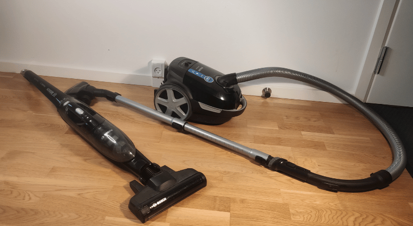 bagless vacuum cleaner and regular vacuum next to each other