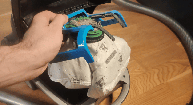 removing a vacuum bag from a vacuum cleaner.