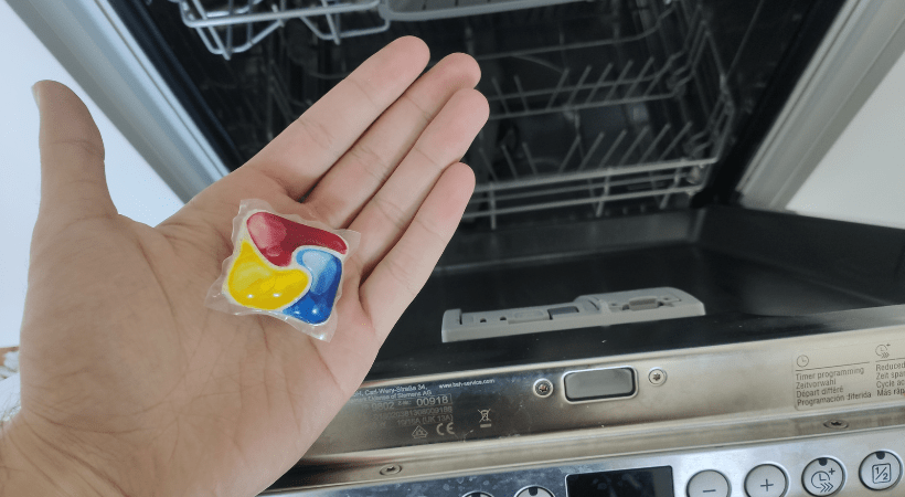 Cleanerd member holds a dishwasher pod in a palm