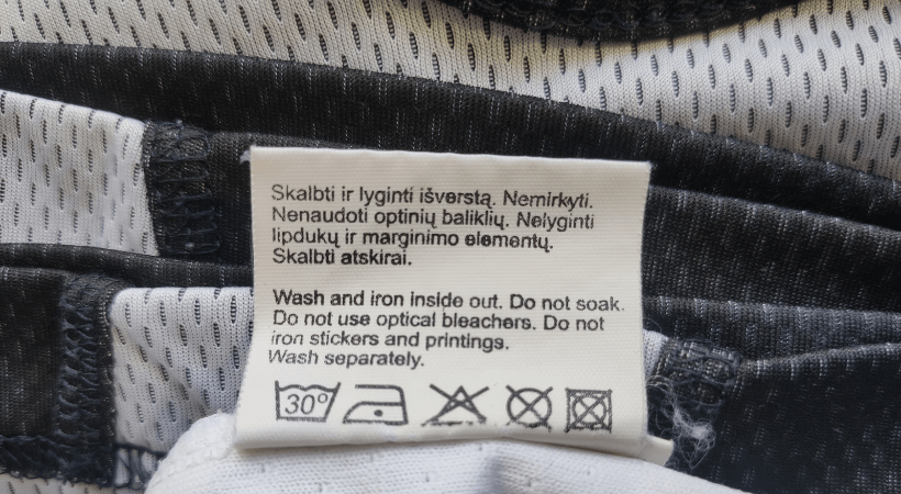 manufacturer's tag with cleaning instructions on a basketball jersey