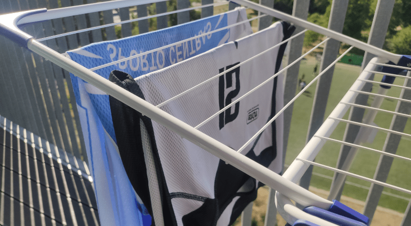 Two basketball jerseys hanging on a drying rack
