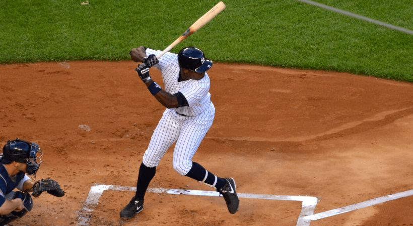 baseball player with white baseball uniform in action