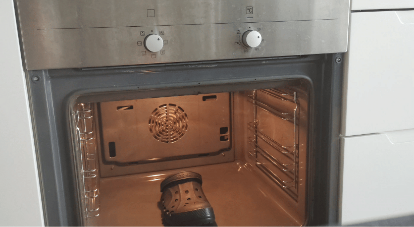 A single Crocs clog inside an oven