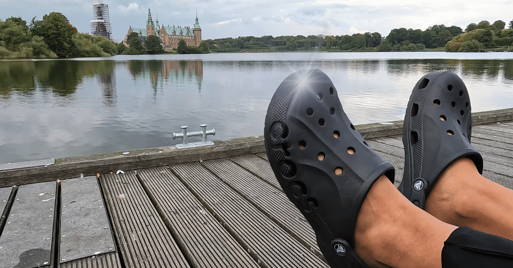 Clean and well maintained black Crocs worn outside