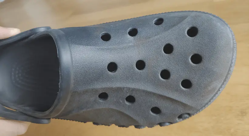 Dirty black Crocs shoe with faded color